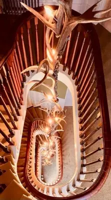 a spiral staircase with a mirror in the middle at Moffat House in Moffat