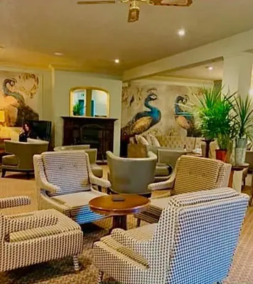a lobby with chairs and a table and a fireplace at Moffat House in Moffat