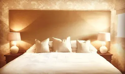 a bedroom with a white bed with two lamps at Moffat House in Moffat