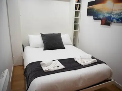 a bedroom with a bed with towels on it at Cosy 1 bed next to SEC, OVO Hydro, Finnieston - Pass the Keys in Glasgow