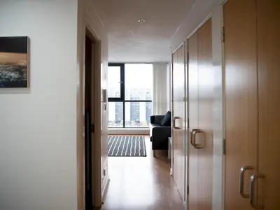 a hallway with a door to a room with a window at Cosy 1 bed next to SEC, OVO Hydro, Finnieston - Pass the Keys in Glasgow
