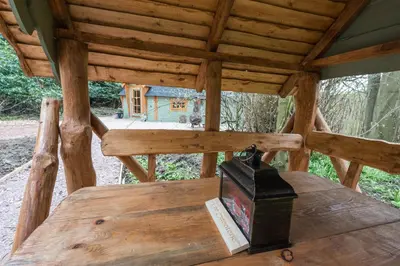 a wooden table with a box on top of it at 1-Bed Cabin 2 Adults Outdoor Bath & Wood Burner in Carluke