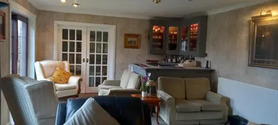a living room with two chairs and a table at CORSBIE VILLA GUEST HOUSE in Newton Stewart