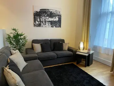 a living room with a couch and a table at Heart of George Street 2 in Oban
