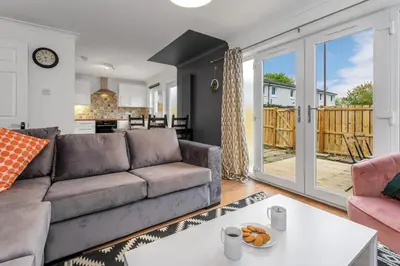 a living room with a couch and a table at Cheerful Stays - Livingston - 4 Bedroom 3 Bath home in Livingston