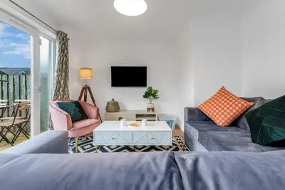 a living room with a couch and a table at Cheerful Stays - Livingston - 4 Bedroom 3 Bath home in Livingston