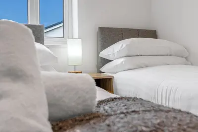 a bedroom with two beds with pillows and a window at Cheerful Stays - Livingston - 4 Bedroom 3 Bath home in Livingston