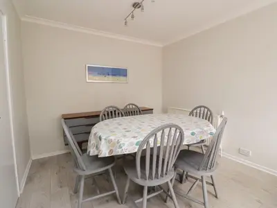 a dining room with a table and four chairs at Willowbank in Ayr