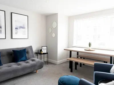 a living room with a couch and a table at Lovely, comfortable 2-bed Braehead - free parking - Pass the Keys in Renfrew