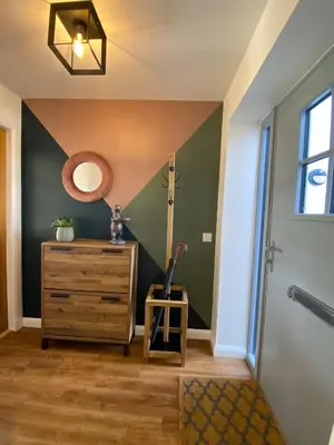 a hallway with green walls and a dresser and a mirror at No 2 The Cairns, Unwind in Style in Oban