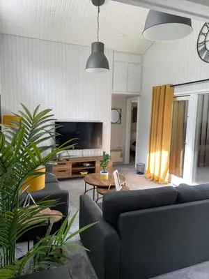 a living room with two couches and a tv at Cherry tree Lodge in Dunoon