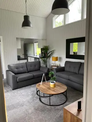 a living room with two couches and a coffee table at Cherry tree Lodge in Dunoon