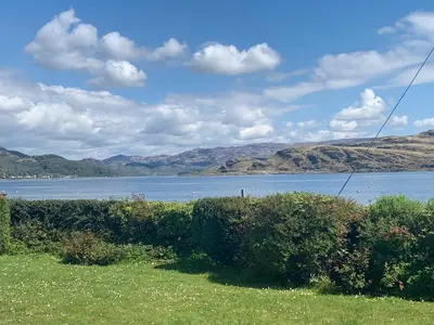 a large body of water with mountains in the background at Taigh An Uillt in Tighnabruaich