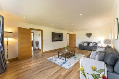 a living room with a couch and a table at Higginsneuk in Airth