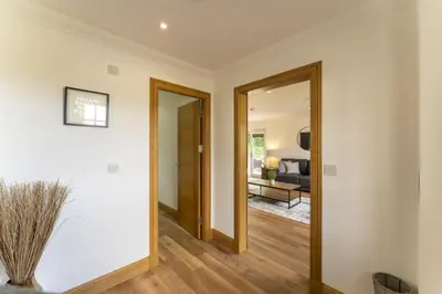 a hallway with a door leading to a living room at Higginsneuk in Airth