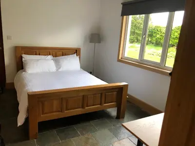 a bedroom with a bed and a window at The Cottage, near Glasgow Milngavie in Milngavie