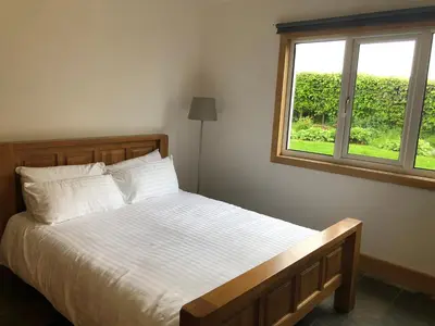 a bedroom with a bed and a window at The Cottage, near Glasgow Milngavie in Milngavie