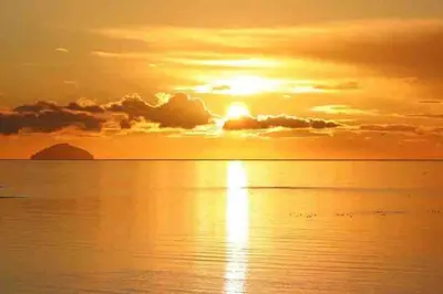 a sunset over the ocean with the sun setting at House - Sleeps 4 Pet Friendly & Free Parking in Symington