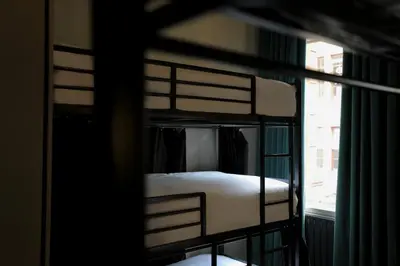 two bunk beds in a room with a window at Revolver Glasgow in Glasgow
