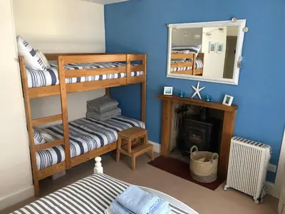 a room with two bunk beds and a mirror at Tighnabruaich Duplex Apartment - Sea Views in Tighnabruaich
