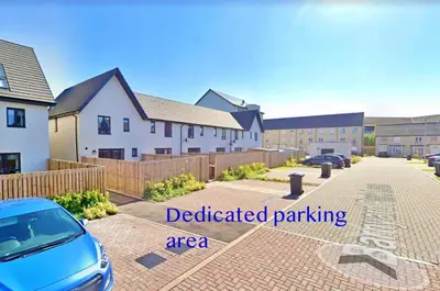 a car parked in front of a residential parking lot at Newbuild - 3 bedrooms, 2 baths,5 mins from airport in Edinburgh