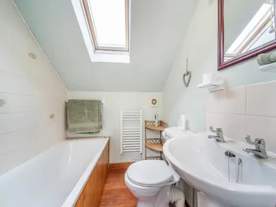 a bathroom with a toilet and a sink and a tub at The Stables - Uk37415 in Bunessan