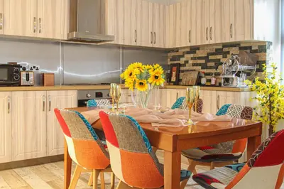 a kitchen with a wooden table with chairs around it at Deluxe Apartment in Lanark