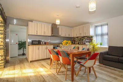 a kitchen and dining room with a table and chairs at Deluxe Apartment in Lanark
