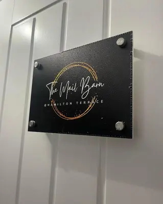 a sign on the door of a bathroom facility at The Mail Barn in Lamlash