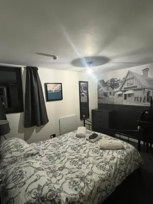 a bedroom with a bed and a light on the ceiling at The Mail Barn in Lamlash