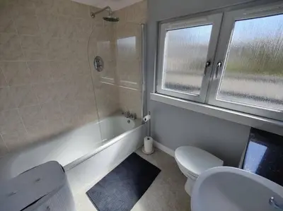 a bathroom with a tub and a toilet and a shower at Fabulous 2BD Maisonette Dunfermline, Fife in Dunfermline