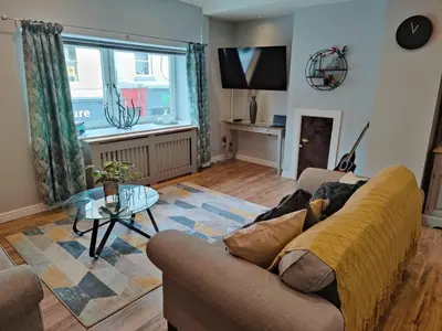 a living room with a couch and a table at Fabulous 2BD Maisonette Dunfermline, Fife in Dunfermline