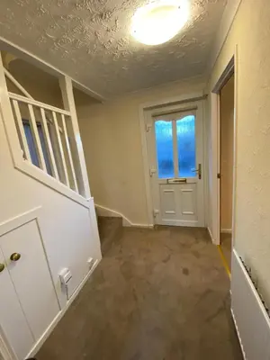an empty hallway with a door and a window at Dunfermline, 2 bedroom home free on street parking in Fife