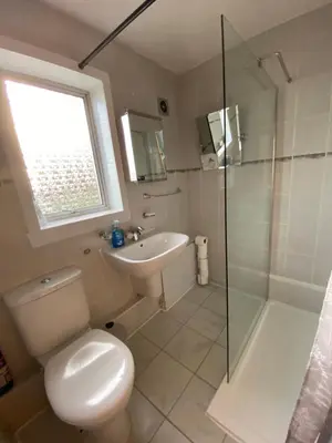 a bathroom with a toilet and a sink and a shower at Dunfermline, 2 bedroom home free on street parking in Fife