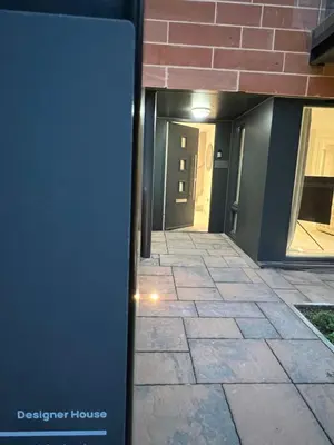 a hallway leading to a building with a door at DESIGNER HOUSE - University of Glasgow / Central Glasgow 'Hillhead' West End G12 - Luxurious & Contemporary Detached House / Terrace / Garden / 'electric car charging' Garage Parking in Glasgow