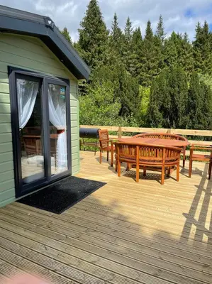 a deck with two benches and a table at The Astoria 41 in Dunoon