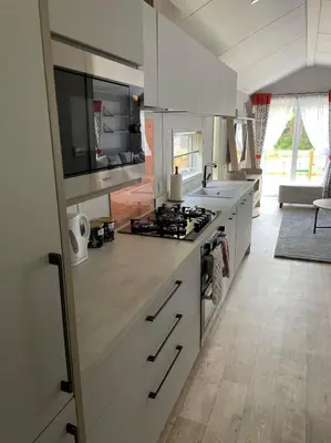 a kitchen with white cabinets and a stove top oven at The Astoria 41 in Dunoon