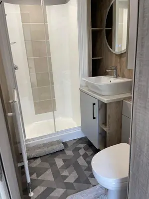 a bathroom with a shower and a sink and a toilet at The Astoria 41 in Dunoon
