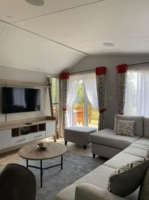 a living room with a couch and a tv at The Astoria 41 in Dunoon