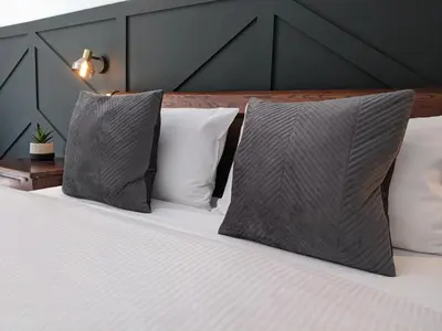 a bedroom with a bed with pillows at Ronachan in Clachan