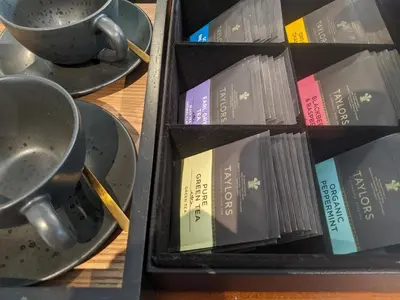 a box of books sitting on a table with a cup at Ronachan in Clachan
