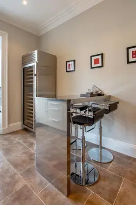 a kitchen with a table and a refrigerator at Exclusive 2 Bed, Free Private Parking, in West End in Edinburgh