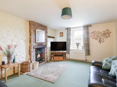 a living room with a couch and a fireplace at Strathannan in Moffat