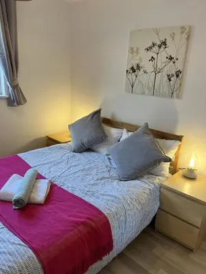a bedroom with a bed with two pillows on it at Bright 2 Bedroom Apartment - Edinburgh in Edinburgh