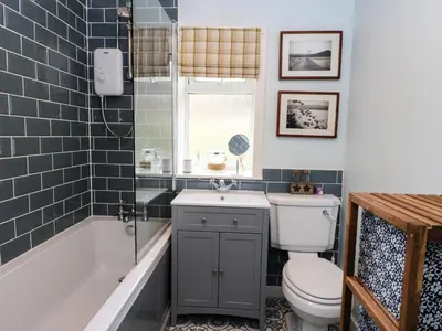a bathroom with a toilet and a tub and a sink at Ben Grianan in Aberfeldy