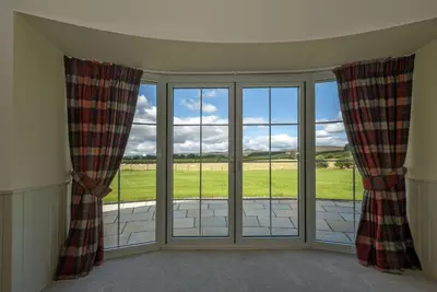 a room with a window with a view of a field at Laverockbank Steading in Buchanty