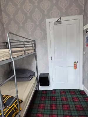 a bedroom with a bunk bed and a white door at IVY House in Edinburgh