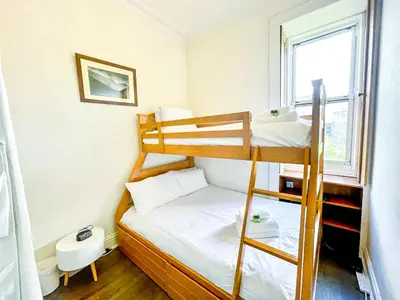 a small room with two bunk beds and a window at Open Plan 2 Bed Apt, Near Edinburgh Castle in Edinburgh