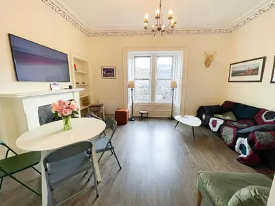 a living room with a table and a couch at Open Plan 2 Bed Apt, Near Edinburgh Castle in Edinburgh
