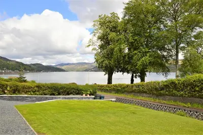 a grassy area with a view of a lake at The Lookout in Tighnabruaich